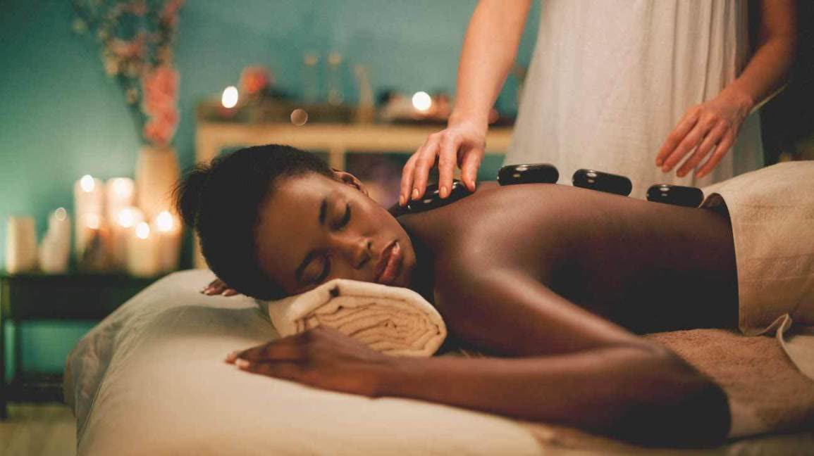 Smooth heated basalt stones used during a hot stone massage in Cheltenham