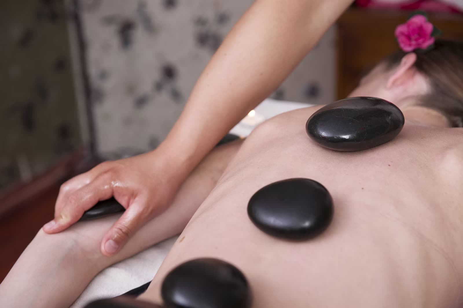 Smooth heated basalt stones used during a hot stone massage in Cheltenham, close up