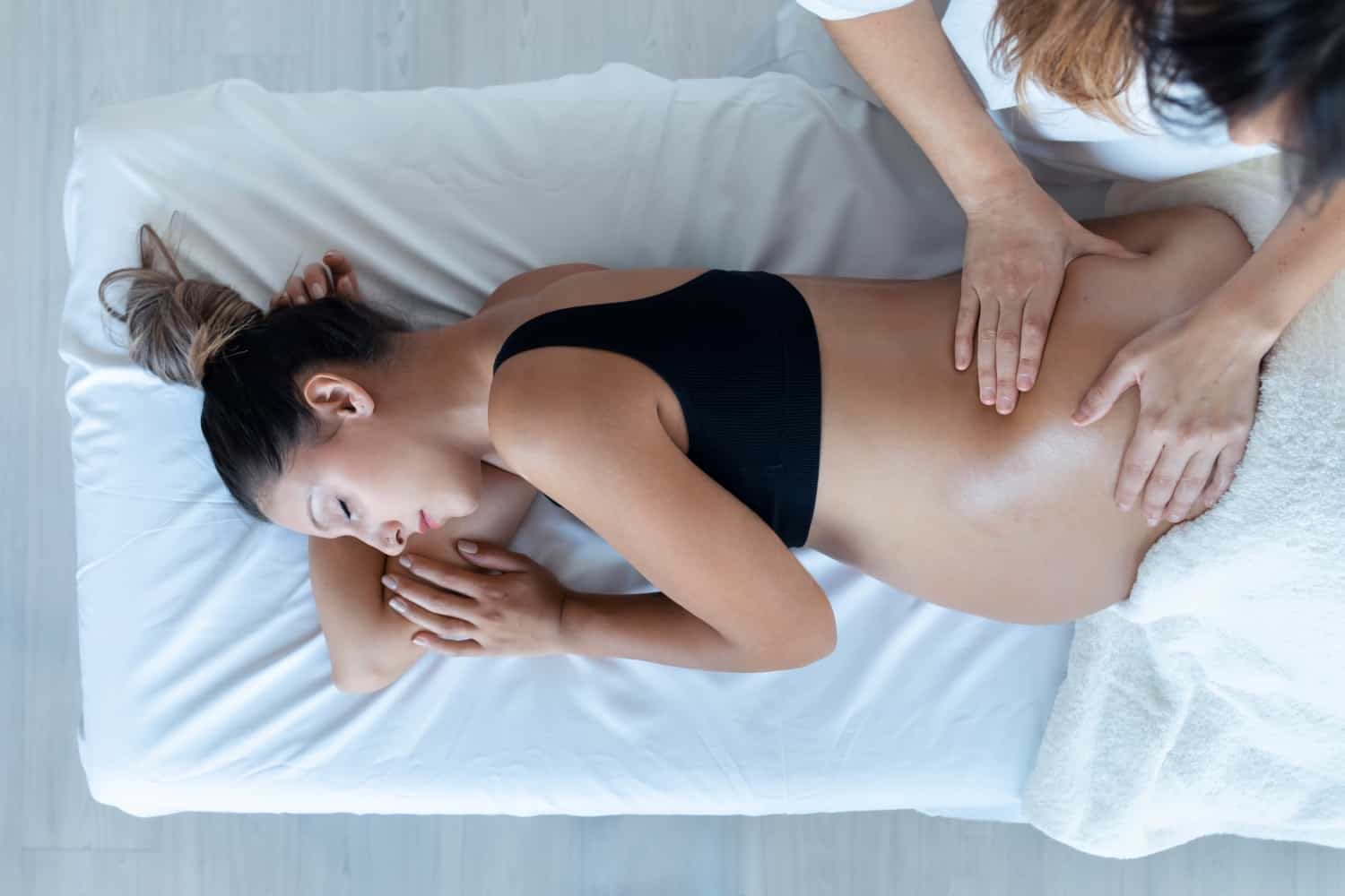 Therapist providing a pregnancy massage in Cheltenham with careful positioning, close up