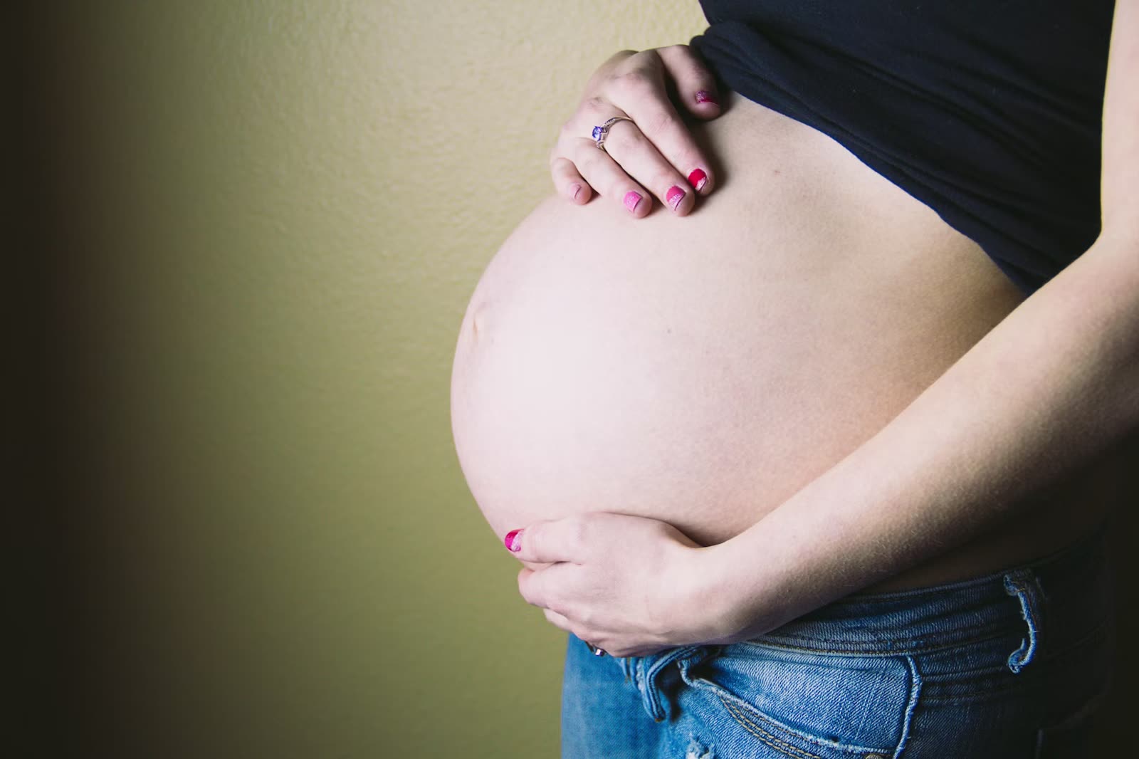 Therapist providing a pregnancy massage in Cheltenham with careful positioning, treatment in progress